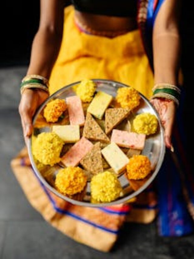 Person Holding Stainless Steel Plate of Traditional Desserts